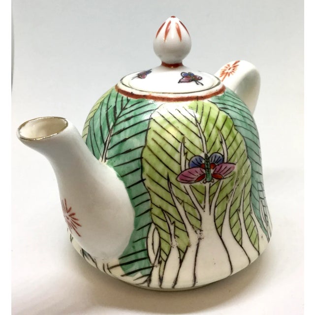 Pure and simple, use this teapot for yourself. Interior holes to keep tealeaves from your cup. This little pot is a copy...