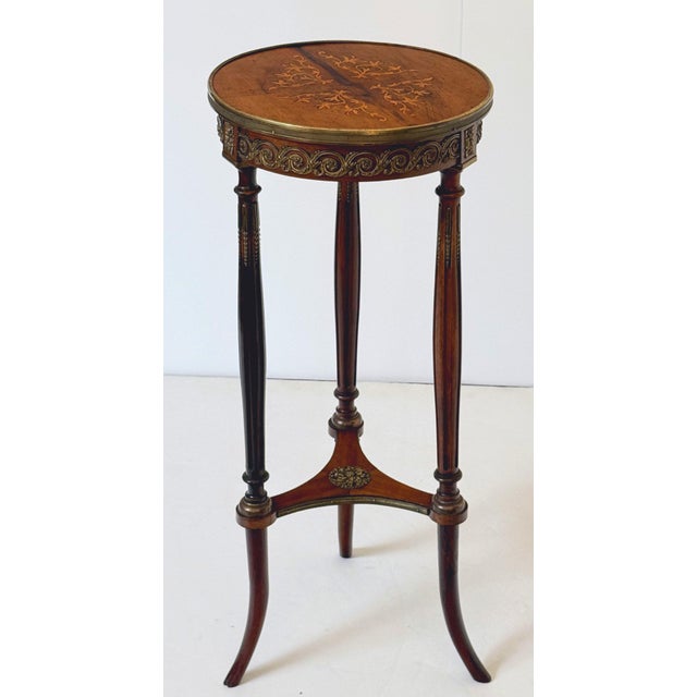 A fine French tripod pedestal or plant stand (gueridon, or torchère) of walnut in the Louis XVI style, featuring a round...