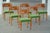 A set of six exquisite dining chairs from the 1930s, crafted in solid elm with elegantly curved backrests adorned in birch...