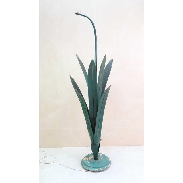 Wonderful floor lamp in the shape of a daffodil. Possibly originally a theatre light Painted metal foliage and wood base...