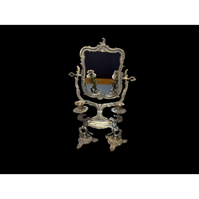 A three-piece handmade brass set featuring an adjustable tabletop mirror and a matching pair of horse-form candlesticks....