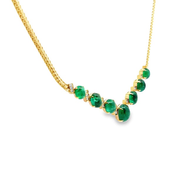 A chic and stylish necklace featuring 7 cabochon emeralds. The 7 emeralds weigh a total of 17.42 carats and have an...