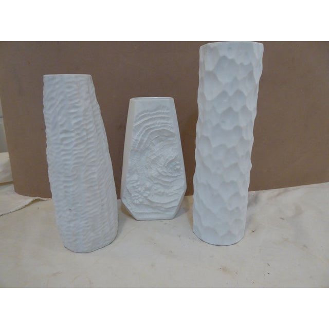 These sculpted porcelain vases are made by German porcelain companies. The tallest, 11.5"H x 3.5"D is by Thomas, the...