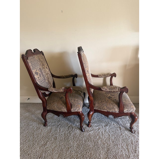 Elegant pair of Century Furniture carved occasional armchairs, model/frame #3217, dating to the circa 1990s. Crafted in a...