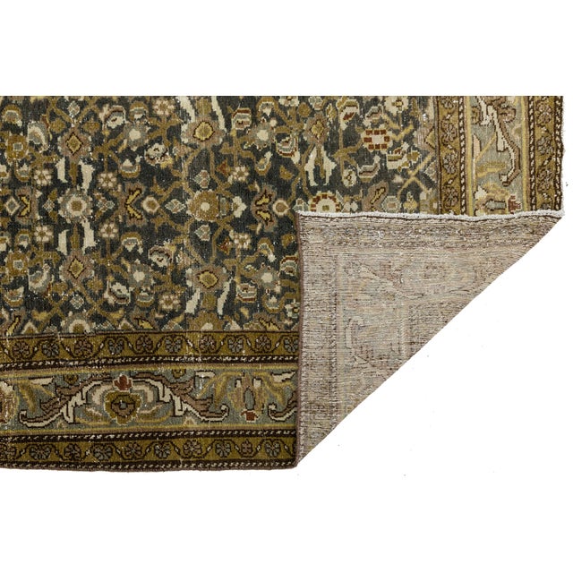 Elevate your space with timeless elegance. Hand-knotted with spun wool, this exquisite 19th-century Antique Mahal rug...