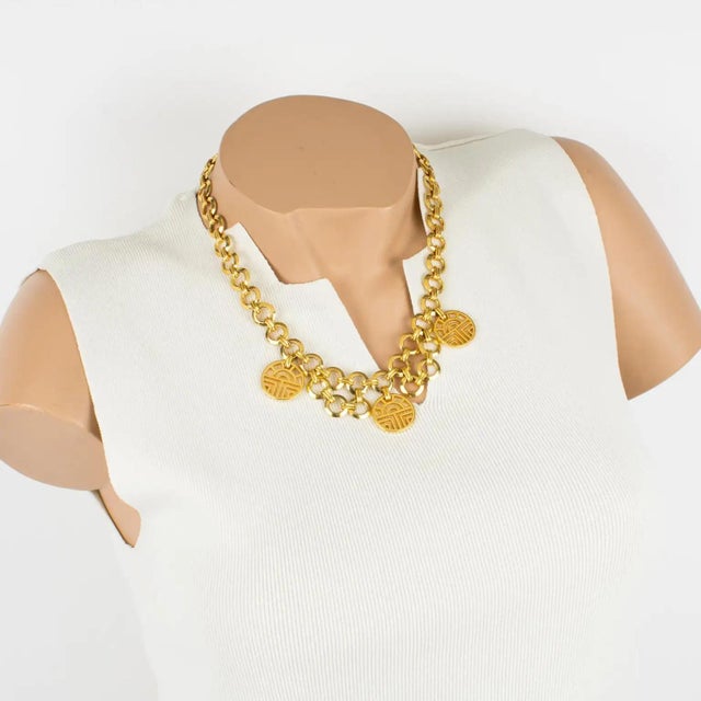 This elegant Louis Feraud Paris choker necklace features a romantic chain-necklace shape and gilded, ornate, iconic brand-...
