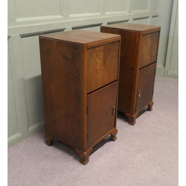 A Pair of Figured Walnut Art Deco Bedside Cabinets This is a very Stylish pair, each one has a storage compartment beneath...