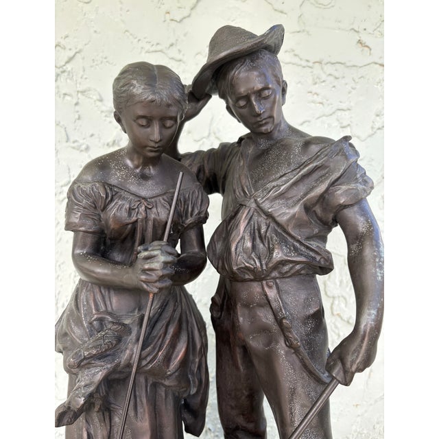 This evocative French figural sculpture depicts “The Angelus,” a traditional rural scene showing a farming couple pausing...