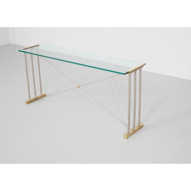Brass and metal console table with glass top. By Peter Ghyczy for Ghyczy, Netherlands, 1970s. Designer - Peter Ghyczy....