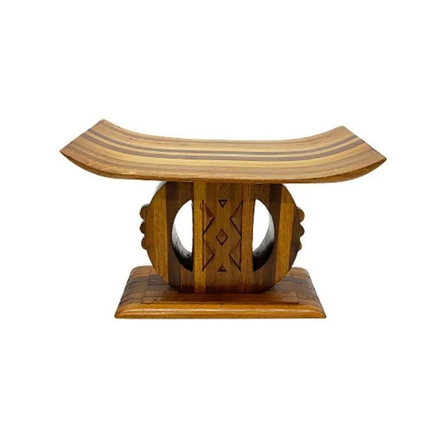 African Ashanti-Asante style wooden stool A 20th century Ashanti form wooden stool with a wide, rectangular and curved...