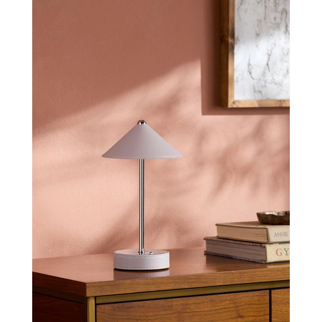 Illuminate your space with a touch of mid-century modern flair, courtesy of the Nomelle accent table lamp. Standing at an...