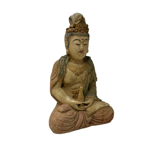 Crafted with a serene and contemplative demeanor, this small wooden Guanyin statue is depicted in a meditative seated...