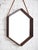 Mid-century Italian hexagonal wall mirror in walnut frame. Features original leather strap. Sourced in Italy.