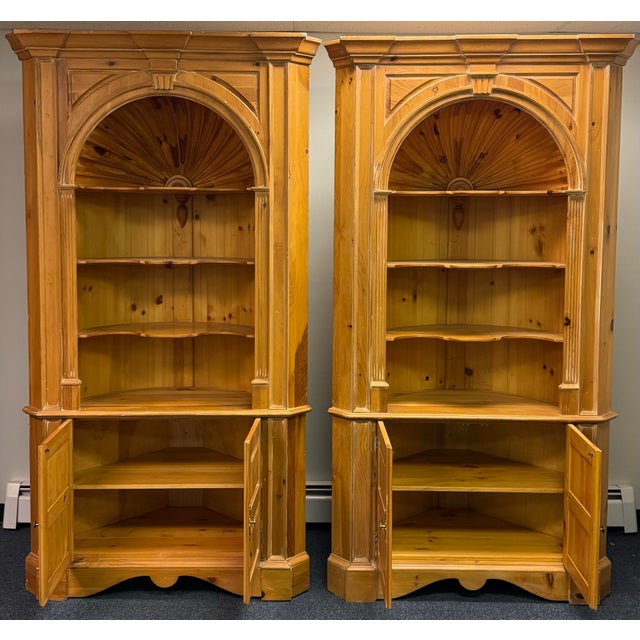 Beautiful pair of Harden Furniture scrubbed pine corner cabinets, featuring a warm, naturally aged finish and impressive...