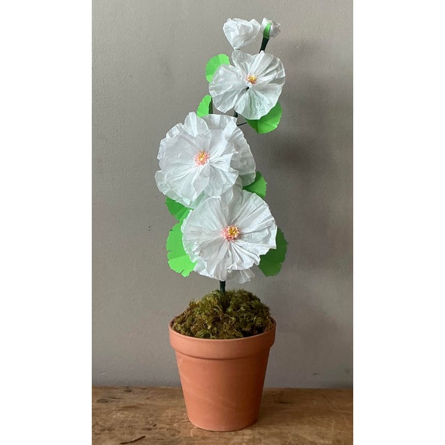 Contemporary hand-rolled paper flowers are a modern, artistic take on traditional floral arrangements. These flowers are...