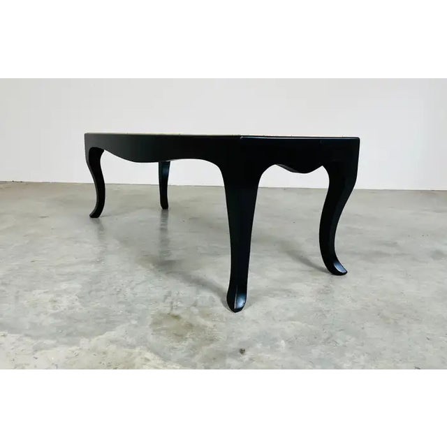 An elegant Mid-Century Modern coffee or cocktail table having Terrazzo marble top inserted into a black lacquered walnut...