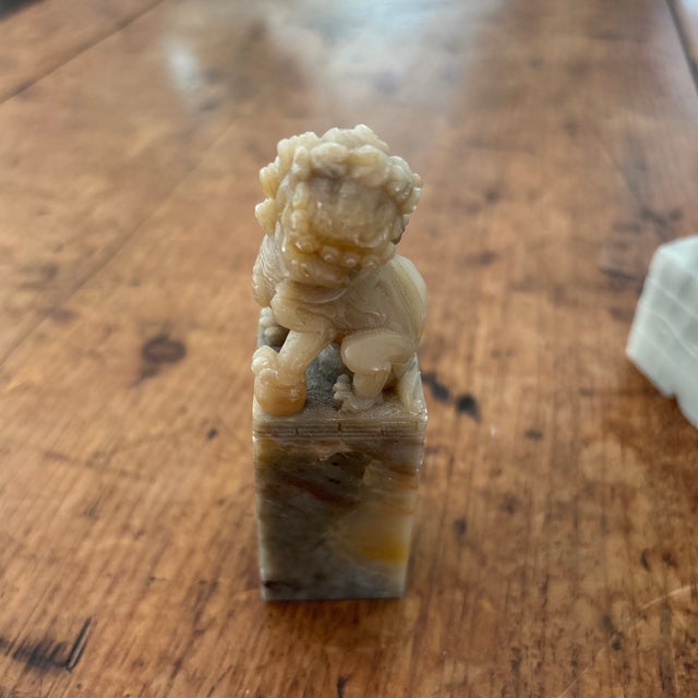 Pair of charming stone Foo Dogs. Large measures approx 5” tall and small 3.5” tall. One is gray & one tan. I have no...