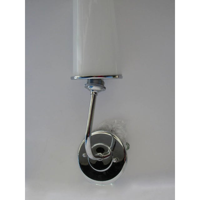 Pair vintage chrome one arm wall sconces with cone shaped glass shades. Un-used. One sconce has a very small crack with is...