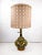 An authentic mid-century statement piece, this table lamp is a vintage smoked glass kerosene lantern-inspired piece. We...