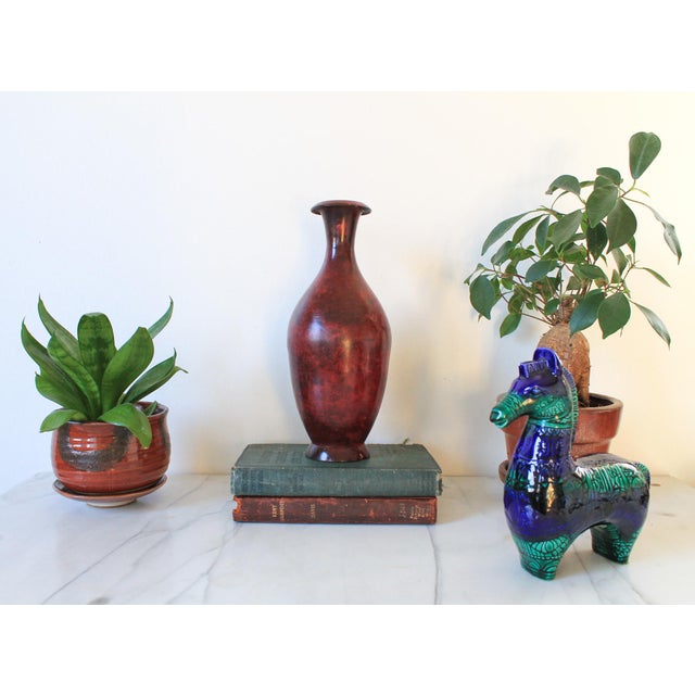 Vintage Oxblood red metal vase. No makers mark. Some age wear. Pictured.