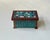 Interesting box or trinket executed in teak and wenge wood and showcasing teal green, blue and white mini-tiles to all 4...