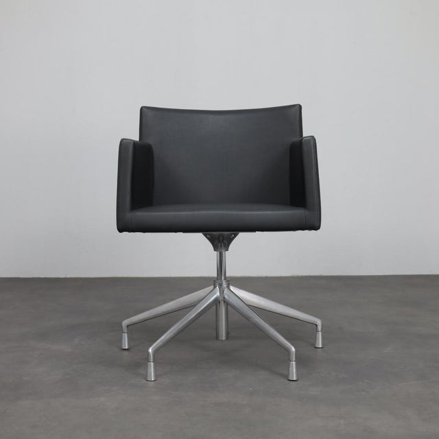 A refined pair of masai swivel armchairs designed by lievore altherr molina and produced by arper in italy during the...