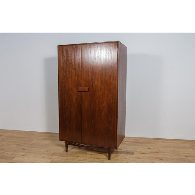 This magnificent mid-century Danish design wardrobe was designed by Ib Kofod-Larsen and manufactured british by G-Plan...