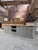 This vintage cabinet has been repurposed as a TV stand. It features a gray-patinated body and a raw wood top. It has 8...