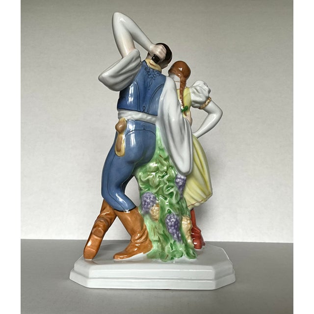 A beautifully hand-painted porcelain figurine by Herend, depicting a romantic pair of Hungarian folk dancers in mid-...