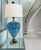 This one‑of‑a‑kind table lamp features a substantial, curving body hand‑blown from aqua art glass by a skilled Seattle...