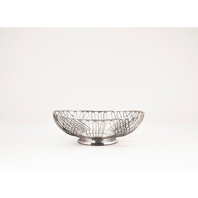 This lightweight, timeless fruit basket crafted from bent metal wire in the Mid Century Modern style combines functional...