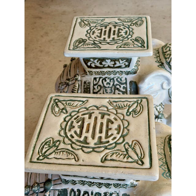 A fabulous and highly decorative pair of vintage terracotta elephant garden seats or pedestals, featuring richly detailed...