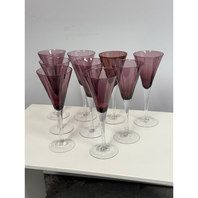 Design Plus Gallery presents a Set of Nine Model Amethyst Champagne Flutes from Pottery Barn. Each flute has a fluted...