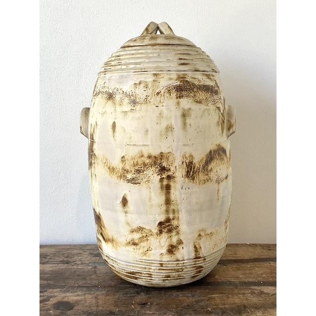 This monumental studio pottery vessel by artist Becky Van is a captivating blend of Brutalist form and Surrealist detail....