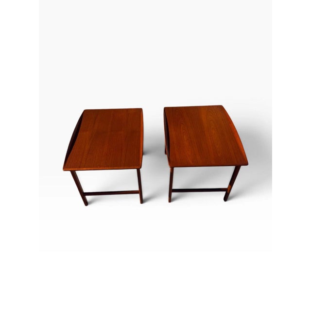 OVERVIEW A matched pair of mid-century modern Swedish teak end tables designed by Folke Ohlsson for DUX, with the maker's...