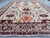 This hand knotted Afghan Sultanabad rug features a classic floral design with a warm ivory field and rich accents of...