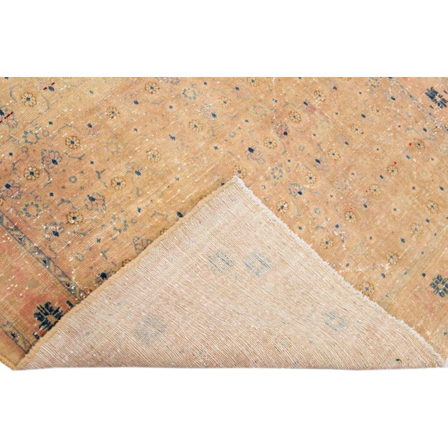 Beautiful Vintage All Over hand-knotted wool rug with a peach field. This rug has blue, pink and tan accents all-over a...