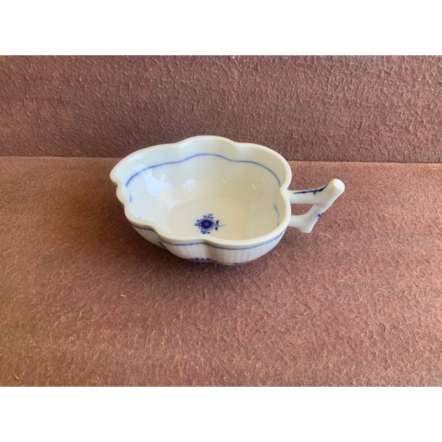 Delicate leaf form gently scalloped rim and a branch stalk handle; great as a nut or pickle dish.
