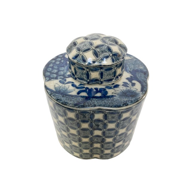 A pretty blue-and-white lidded jar with a timeless classic geometric floral pattern. A rich palette of deep blue and soft...