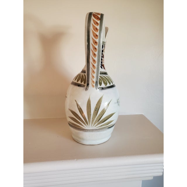 Stunning handpainted vintage Mexican Jug. Has both a floral and agave motif painted in soft colors. Large size makes it...