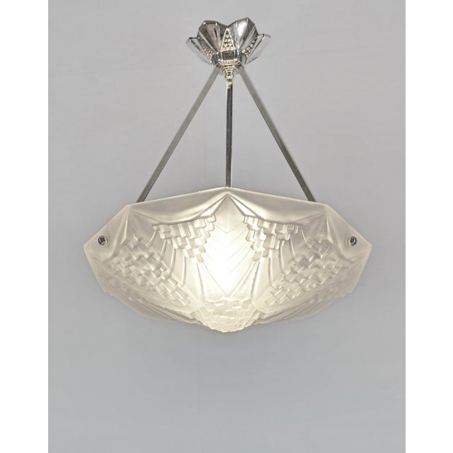 André Neut A very nice French art deco pendant made around 1930 in nickel plated bronze or solid brass holding a bowl in...