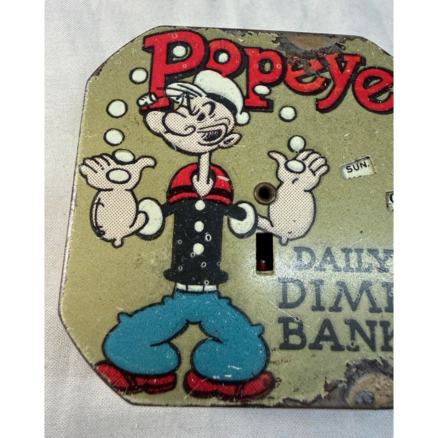 This vintage original 1956 Popeye the Sailor Man daily dime coin still bank is a rare and collectible piece from the...