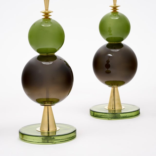 Pair of hand-blown Murano glass lamps featuring unique glass components on a brass structure. In the style of iconic...
