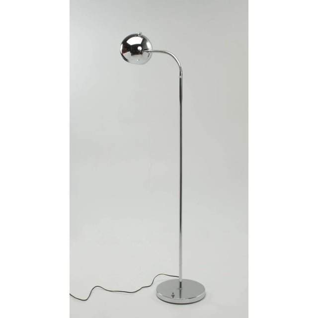 A mid century modern chrome floor lamp after lamps by Robert Sonneman with a single ball head and a fully adjustable...