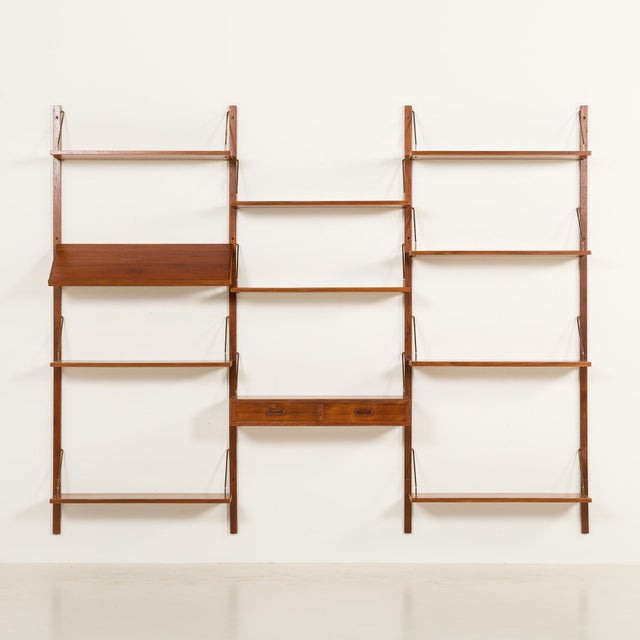 This danish teak wall unit with a console is reminiscent of the iconic 1960s modular furniture designed by poul cadovius...