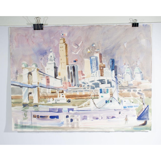 A watercolor painting by the American artist Sanford Brooks (1915-1994). This painting depicts a riverside cityscape...
