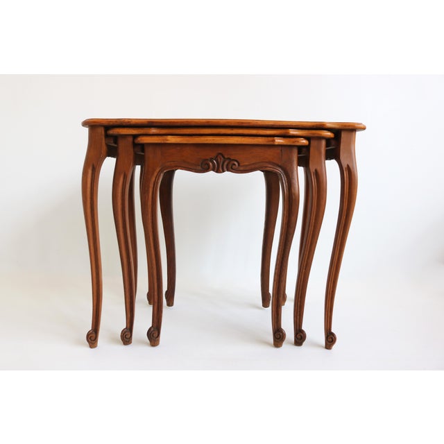 Elegant set of three french nesting tables in the louis xv style, crafted from oak in the 1960s–70s. Each table features a...