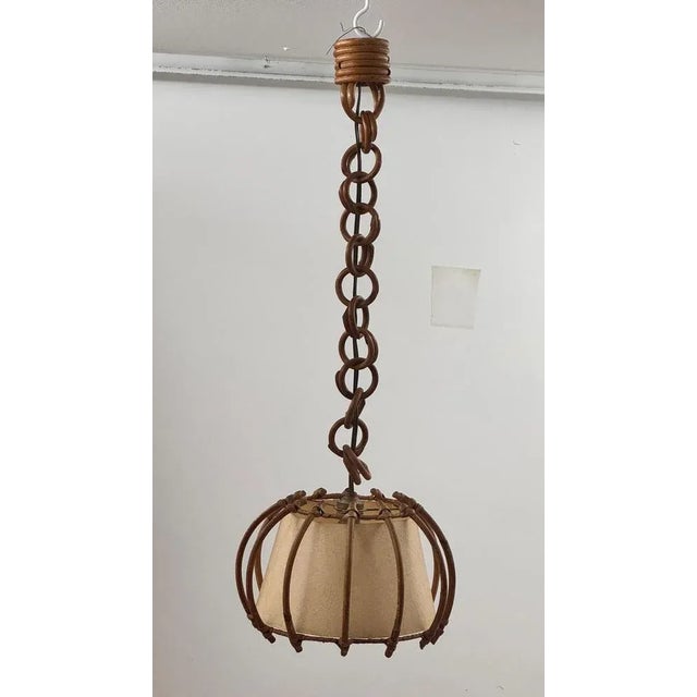 This is a rare pendant lamp made in France in the 1960s, crafted in wicker (jonc) and paper, reflecting the Southern...