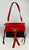 NWOT condition. red and black leather exterior with tassel details and gold hardware. black and red leather interior with...