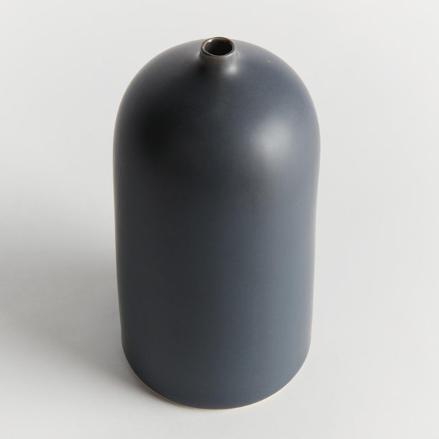 Simple in form with a modern aesthetic, this vase is the definition of less is more. Finished in a smooth dark navy, matte...